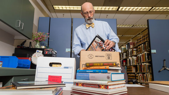 Professor with small pile of books